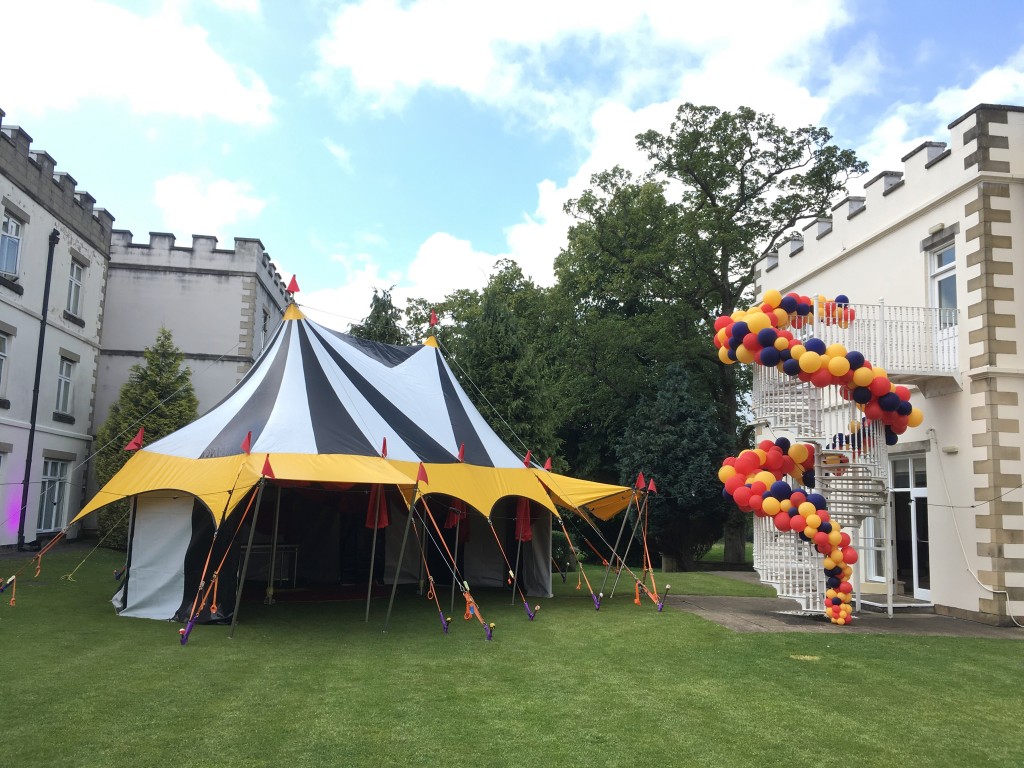 black and white big top for hire with colourful balloons