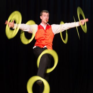Circus artist on a stage with rings