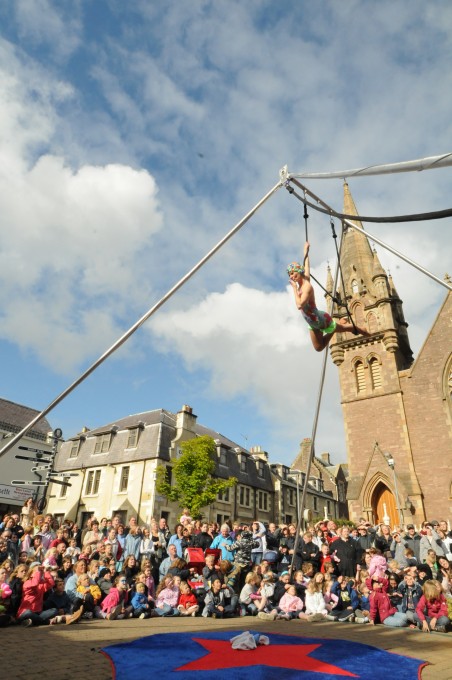 trapeze performer and crowd